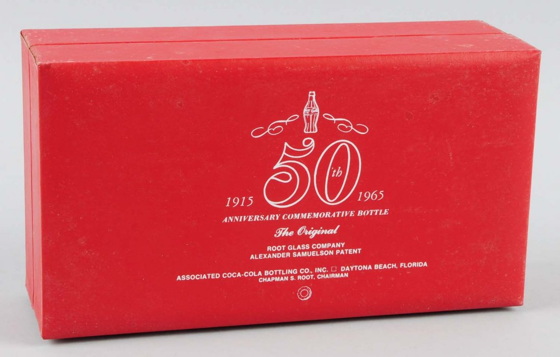1965 anniversary Coca-Cola Bottle & Case.: Beautiful with just outer case soiling. Condition (Near Mint). Size 9 - 1/2" L.