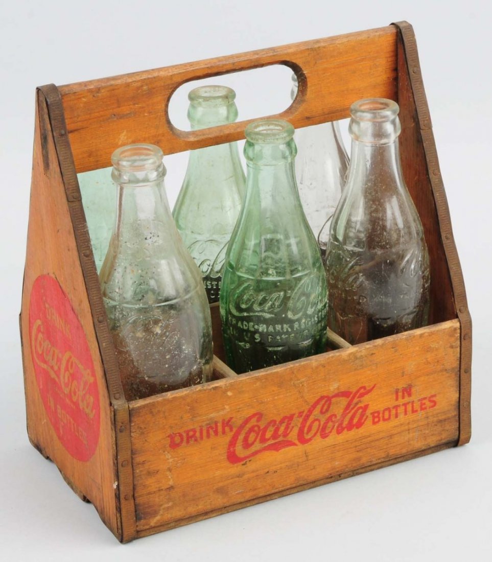 Coca-Cola Wooden Carrier with 6 Bottles.: 1940s with moderate wear and slightly darkened. Condition (Excellent). Size 9" T.