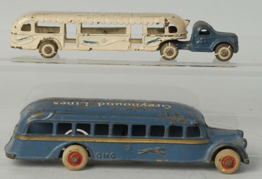Lot of 2: Cast Iron Arcade Greyhound Bus Toys.: One says Greyhound Lines GMC on the top. Second is a tractor trailer made for the 1933 Chicago Worlds Fair. Both have white rubber tires. Some paint loss and wear. Especially to roofs. Condition (Very