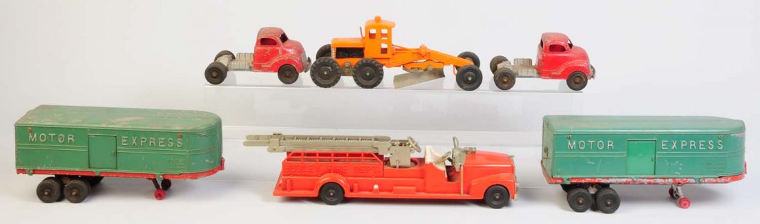 Lot of 4: Hubley Die Cast Vehicles.: Includes a road grader, a Hubley Fire Department ladder truck and two motor express semis. Various conditions. Significant paint loss and scratching throughout. Condition (Good - Very Good). Size Larg