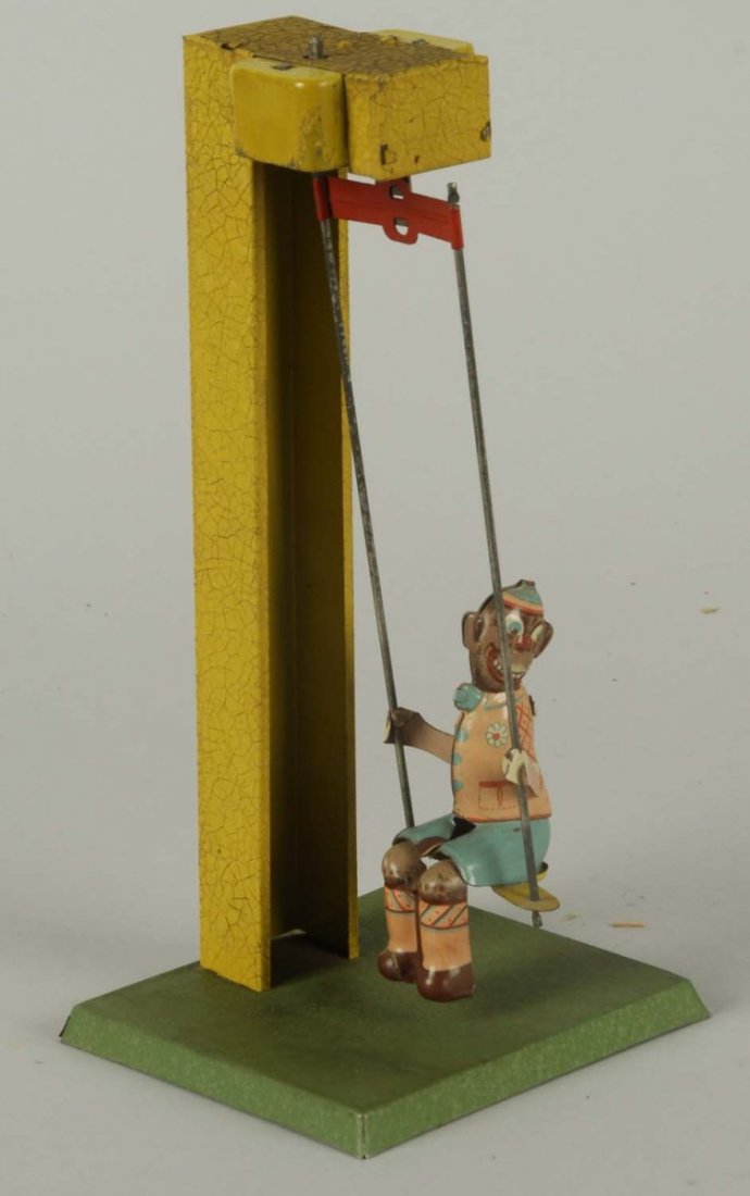Tin Wind-up Monkey on Swing Toy.: Made in US zone Germany. Is very unusual. Appears all original and complete. Some slight wear throughout. Condition (Very Good - Excellent). Size 9" T.