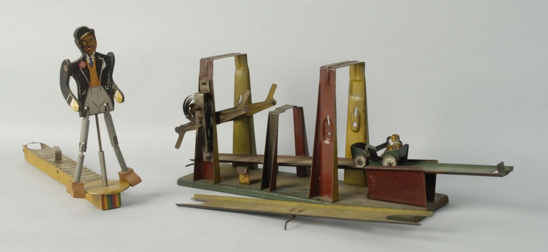 Lot of 2: Vintage Tin Mechanical Toys.: One is an over/under toy probably made by Wolverine with the original car. Second is a African American man lever activated dancer. Which is probably Canadian made. Condition (Very Good). Size Largest