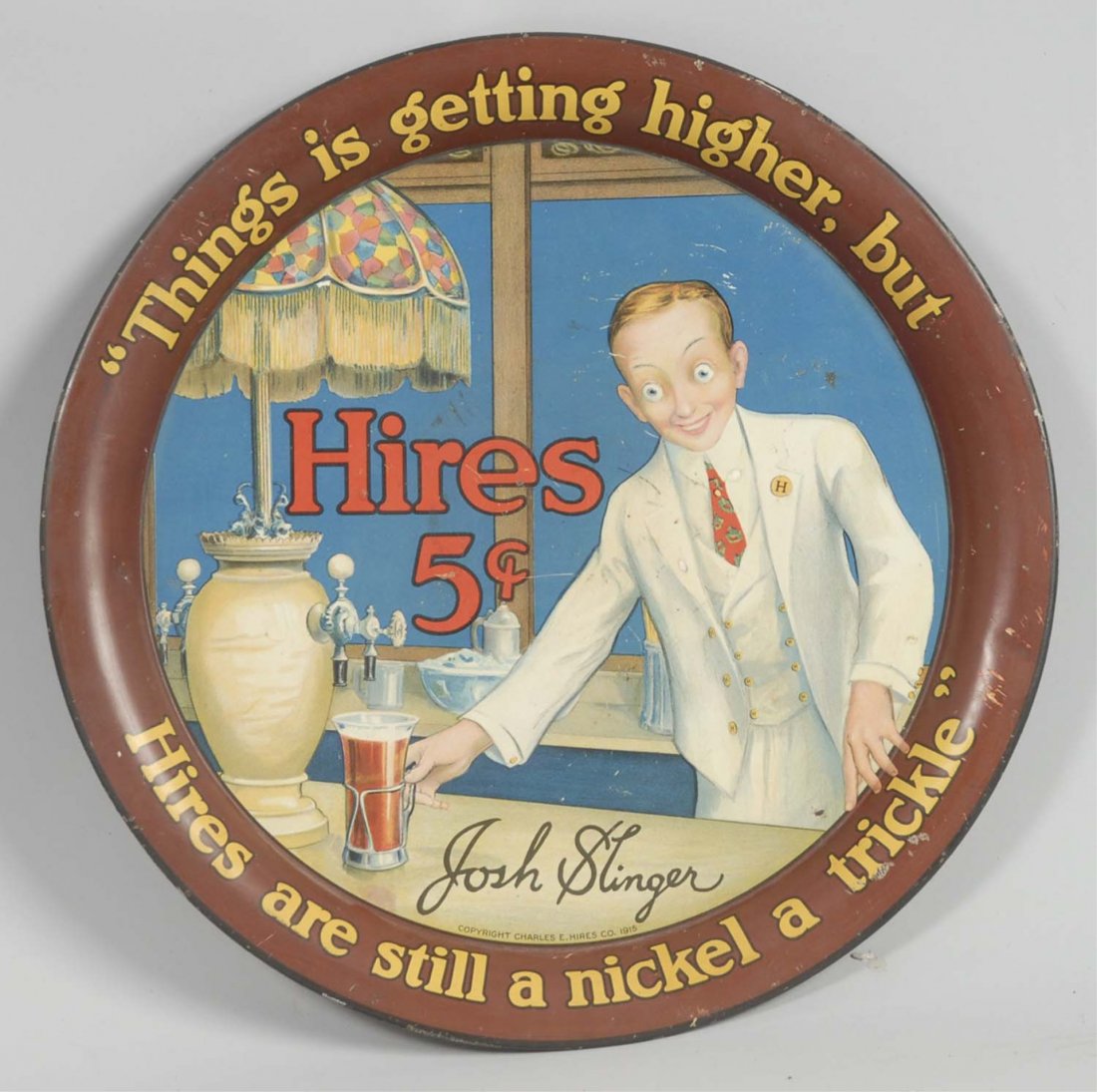 Hires 5¢ Serving Tray.: Popular tray amongst collectors which features Josh Slinger in the center serving a glass of Hires Root Beer. Dated 1915. Has a nice overall appearance with minimal surface wear with some scattered ni