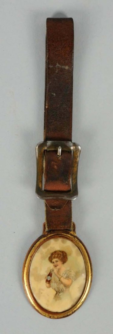 1910 Coca-Cola Celluloid & Brass Watch Fob.: Not so commonly found, and details still display well in spite of some mild foxing stains and bumpy surface. Condition (Very Good). Size 5 - 3/4" T.
