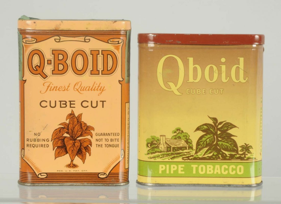 Lot of 2: Qboid Pocket Tobacco Tins.: Includes the cube cut and the cabin variations. Minimal overall wear. Condition (Near Mint). Size Largest: 4 - 1/2" T.