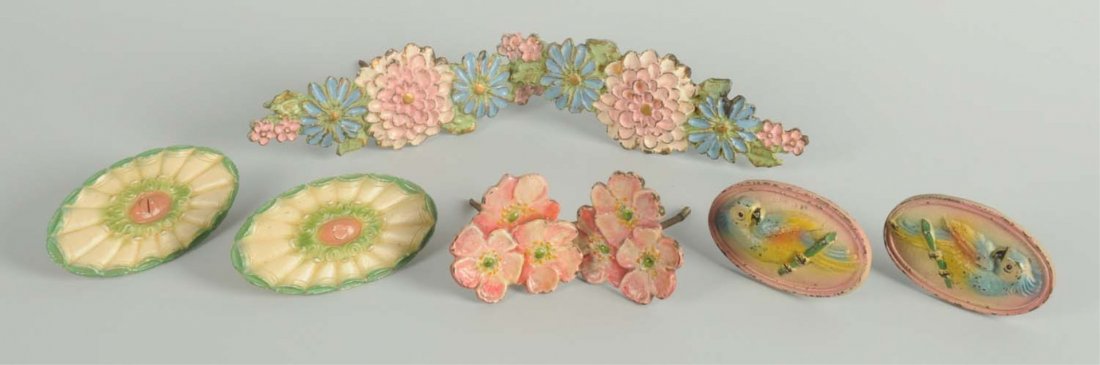 Cast Iron Flower & Cockatoo Curtain Tie-Backs.: Depicts Dogwood Flowers, “1926”; Flower Medallions, “837-2”; Zinnias, “Pat. Appl’d For, LVL”, made by Candlestick Co.; Cockatoo, Creations Co. Condition (Excellent). Size Largest: 7 - 1/