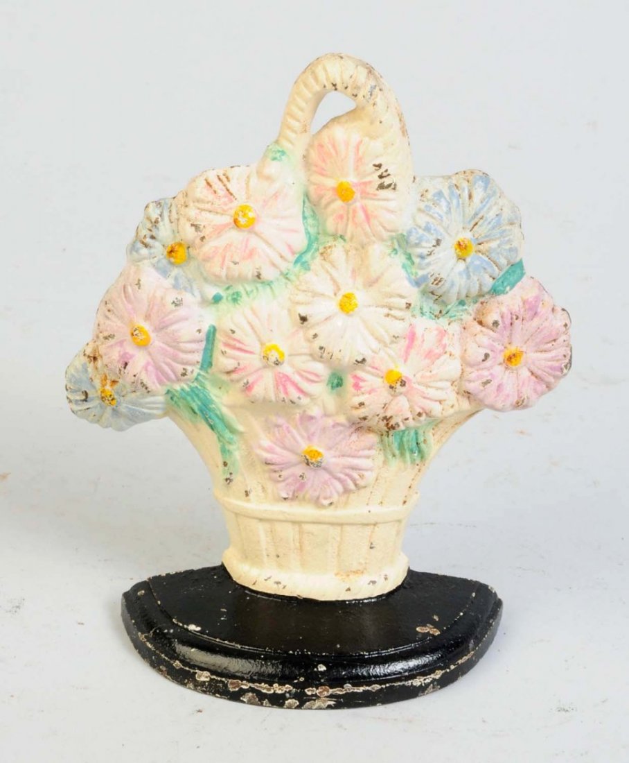 Cast Iron Daisies in Basket Doorstop.: Multi-colored flower daisies in splint basket. Made by Hubley and numbered "344". Condition (Excellent Plus). Size 6 3/4" T.
