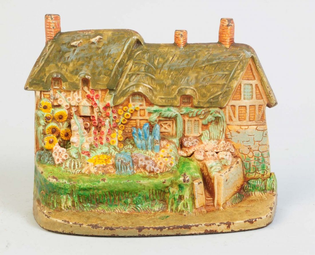 Cast Iron Ann Hathaway Cottage Doorstop.: Depicts Ann's cottage with a thatched roof and adorned in hollyhocks and other flowers. Two piece casting. Hubley, cat #438. Condition (Excellent). Size 8 3/8" L.