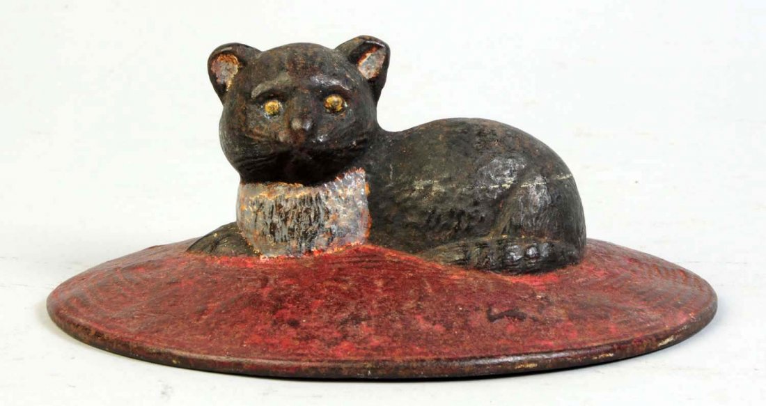Cast Iron kitten on Oval Rug Doorstop.: Full-figure, solid casting. Made by Albany Foundry Co., cat. #105. Condition (Excellent). Size 2 5/8" T.