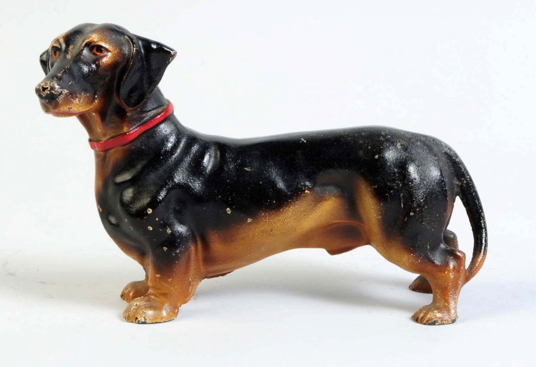 Cast Iron Dachshund Dog Doorstop.: Done in realistic paint with exceptional form and casting. Made by Hubley, cat. #326. Signed, "Made in USA". Condition (Excellent). Size 6 - 1/4" T.