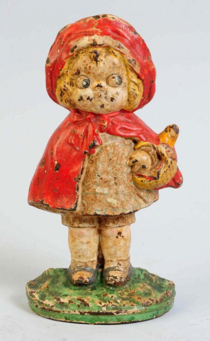 Cast Iron Little Red Riding Hood Doorstop.: Little Red Riding Hood standing holding basket. Grace Drayton design. Made by Hubley, cat. #95. Condition (Good). Size 7 3/8" T.