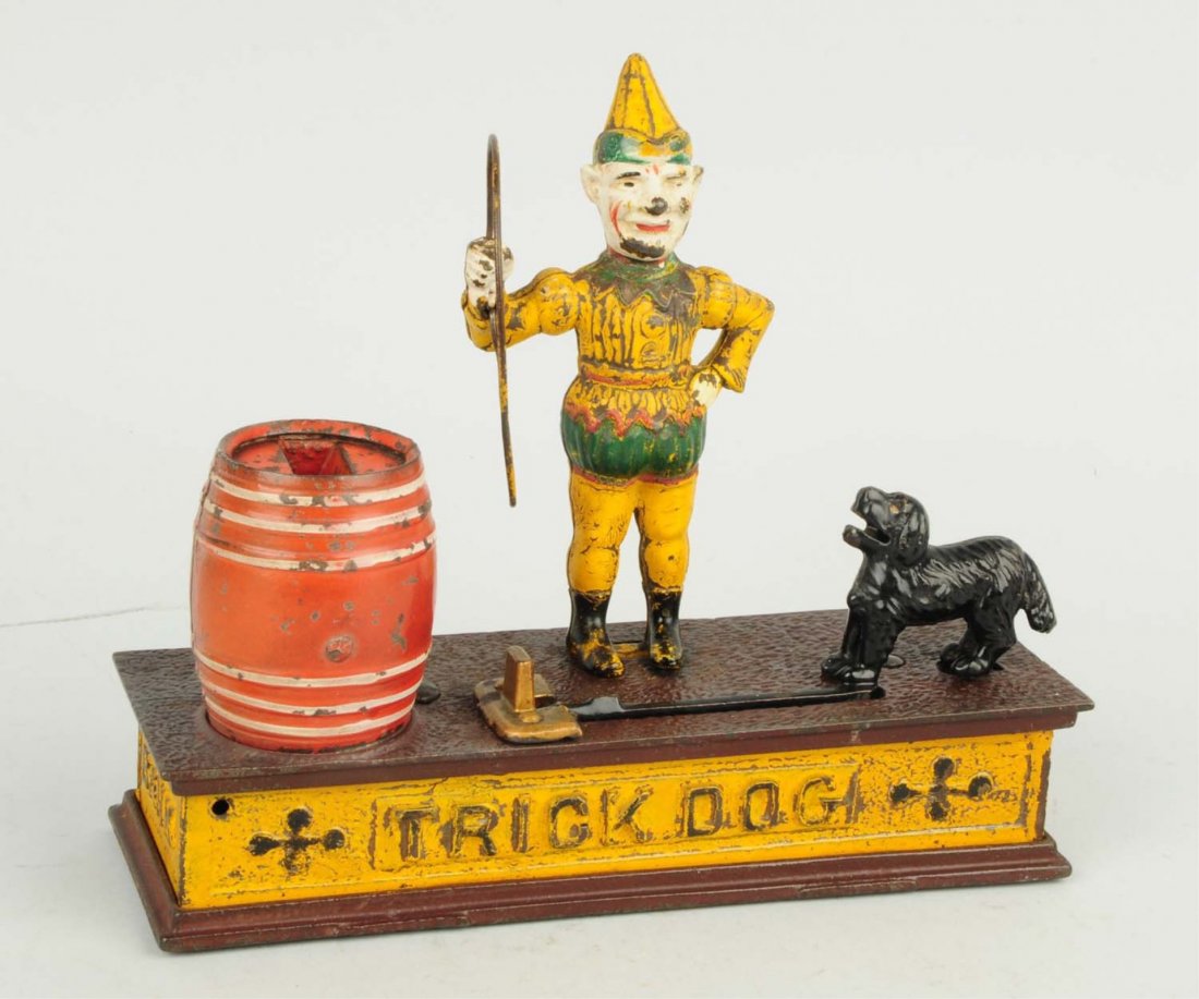Cast Iron Trick Dog Mechanical Bank.: Hubley Manufacturing Co., Circa 1896. "The coin is place in the dogs mouth, and by touching the lever the dog jumps through the hoop and deposits coin in the barrel. Condition (Excellent Plus). Size 9