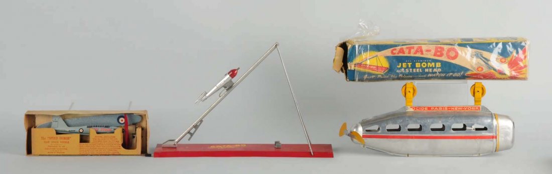 Lot of 3: Misc. Aviation Toys.: Includes an English Speed Demon, a Cata-bo Jet Bomb airplane, and a tin monorail vehicle marked "Paris - New York". Two toys are in original boxes. Condition (Very Good). Size Largest Box: 17 - 1/4" L