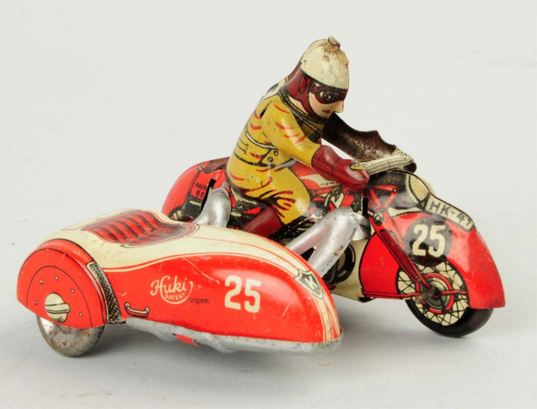 German Tin Litho Wind-up Huki Motorcycle Toy.: Has side car. Marked No.25 on front and also HK-41 on fenders. Huki is written on side car. Some minor scratching and wear. Condition (Very Good - Excellent). Size 3 - 1/2" L.