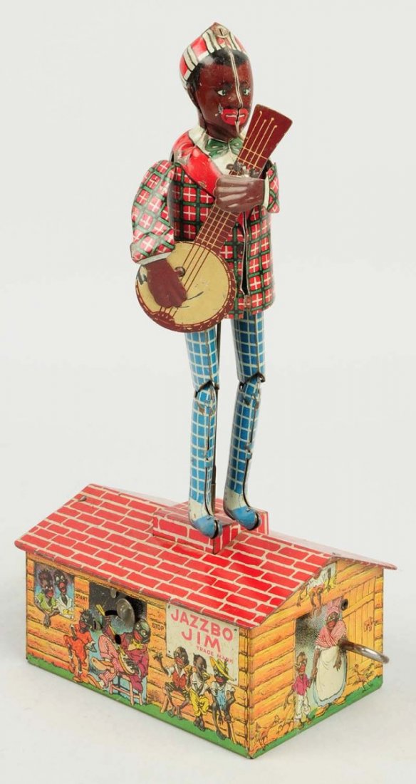 Strauss Tin Wind-up Jazzbo Jim Dancer Toy.: Toy is all original. One arm is loose from the toy. Does have some slight play wear and corrosion throughout. Condition (Very Good). Size 10" T.
