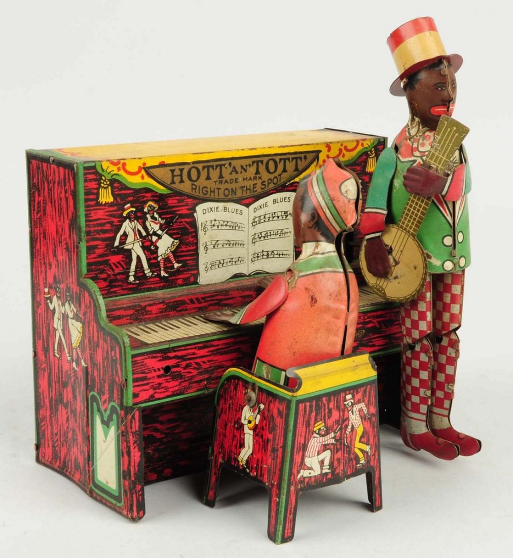 Unique Art Tin Wind-up Hott`an`Tott` Toy.: Toy appears to be all original including arms on the figures. Does have some play wear and scratching. Has some corrosion throughout. Condition (Very Good). Size 7" L.