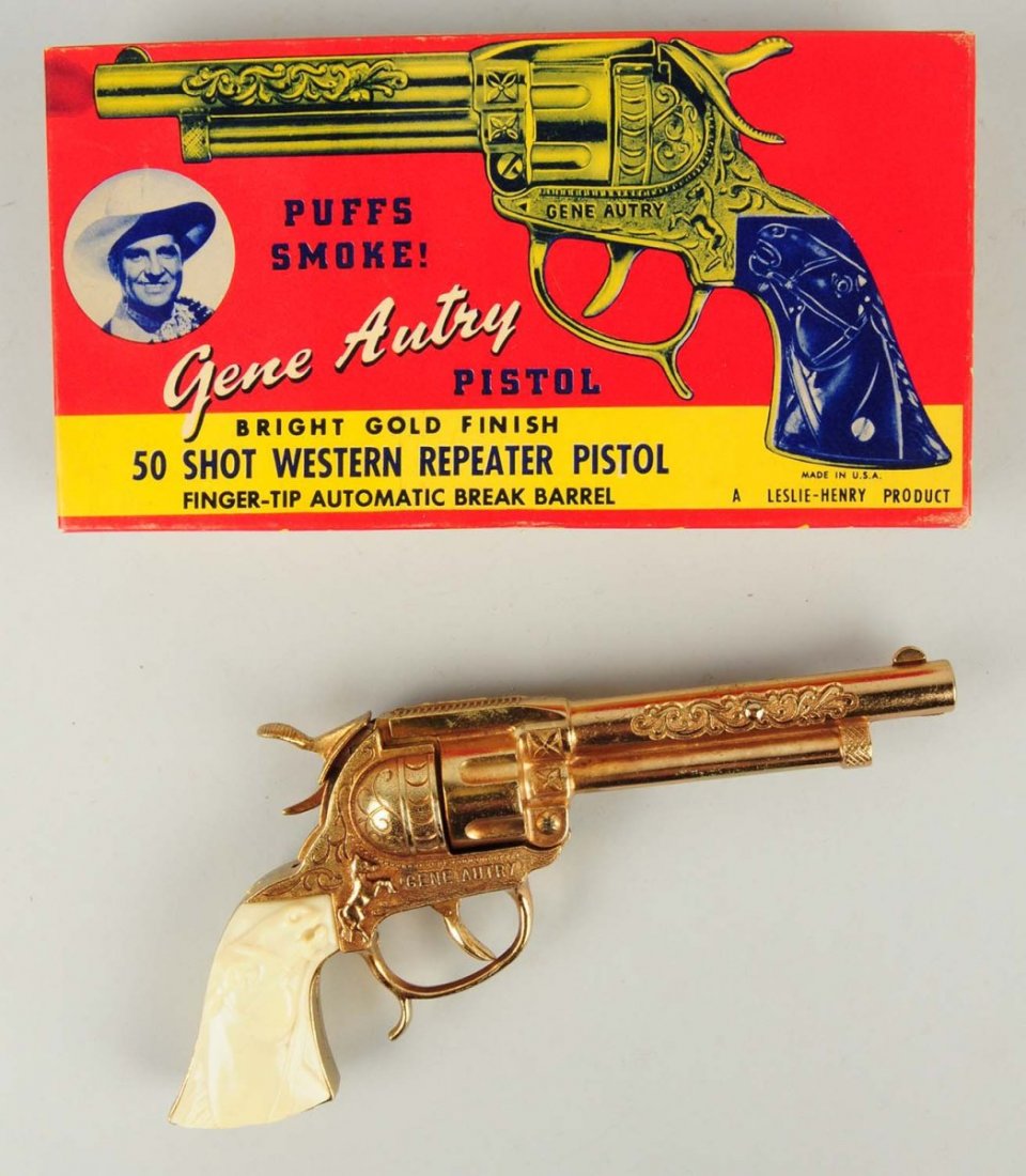 Leslie Henry Gene Autry Pistol.: Pistol has a bright gold finish. Is a 50 shot Western Repeater. Gun is all original with excellent finish. Comes with original box. Condition (Excellent). Size Box: 9" x 4 - 3/4".