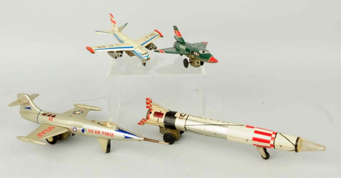 Lot of 4:Japanese Tin Litho Friction Airplane Toy: Includes US Airforce jet, marine jet, Oriental Air liner, and one Airforce rocket. Some moderate wear. Condition (Very Good - Excellent). Size Largest: 13" L.