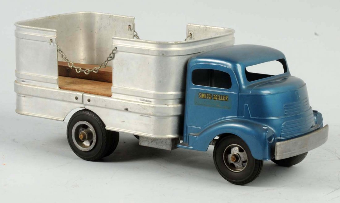 Pressed Steel Smith-Miller Open Bed Toy Truck.: Has two chains on rear with open sections. B Mack cab front with Smith-Miller decals on sides of doors. Front cab looks to be restored. Back is original. Condition (Very Good). Size 14" L.