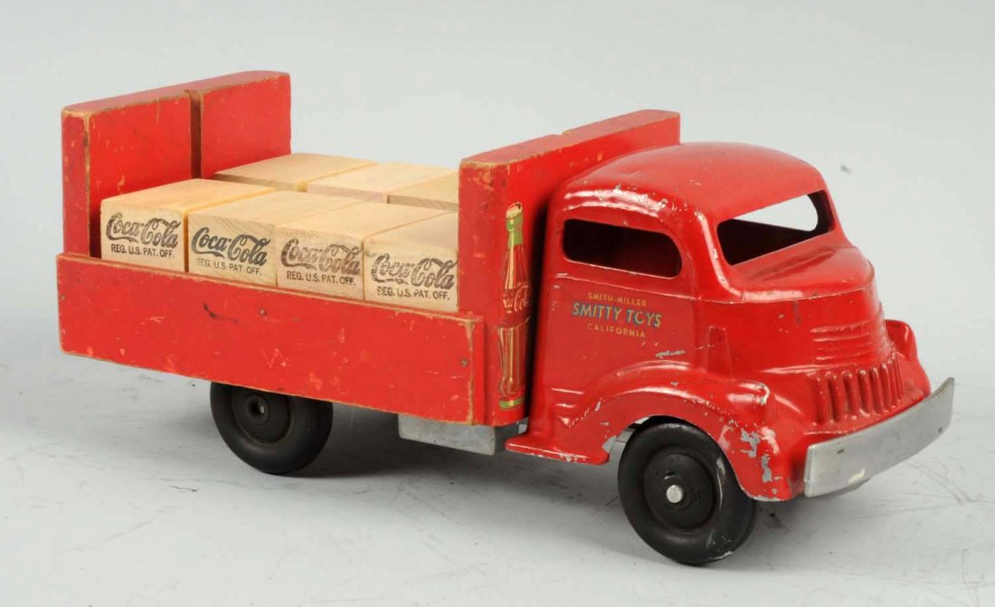 Pressed Steel Smith-Miller Coca-Cola Truck.: Marked "Smitty Toys" on decals on sides of front B Mack. Has eight wooden Coca-Cola boxes in rear which look to be replacements. Also missing wire to hold in carriers. Pressed Steel front with wooden 