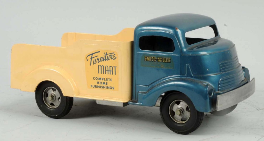Pressed Steel Smith-Miller Furniture Mart Truck.: B Mack front. Decals on side say "Furniture Mart Complete Home Furnishings". Looks to have been professionally restored. Very little wear. Condition (Excellent). Size 13" L.