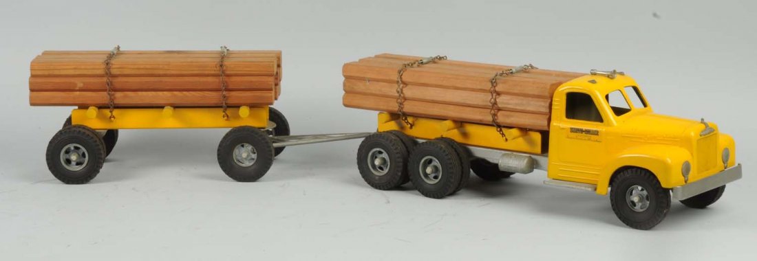 Pressed Steel Smith-Miller Log Tandem Truck.: Nice decals on sides. Scarcer L Mack front. Has original chains. Possibly restored. Condition (Very Good - Excellent). Size 36" L.