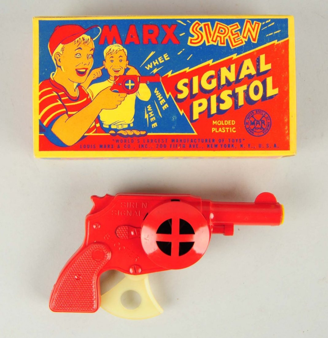 Marx Siren Signal Toy Pistol.: Includes original box. Is a scarce red color. Unused old store stock. Condition (Near Mint). Size 7" L.