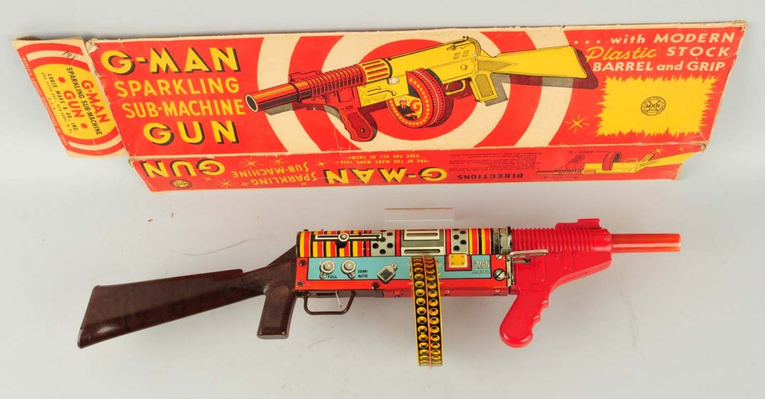 Marx Wind-up G. Man Sparkling Toy Machine Gun.: Includes original box. Box is missing flaps on one side and does have some tearing and creasing. Gun is tin litho and plastic. Some scratching and wear. Condition (Very Good - Excellent). Size 25" L.