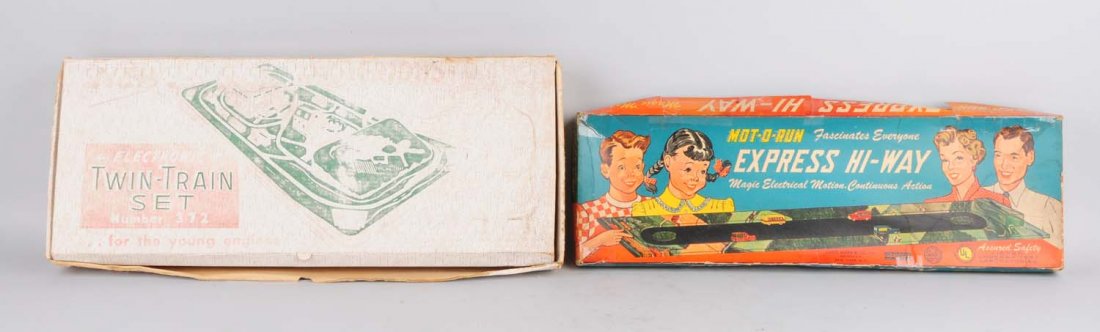 Lot of 2: Tin & Plastic Toy Highway Sets.: Both are in original boxes. One is Marx and the other is made by Woodhaven Toy Company. Both boxes have some creasing and some tape on the corners. The Woodhaven set has a small tin litho train and th