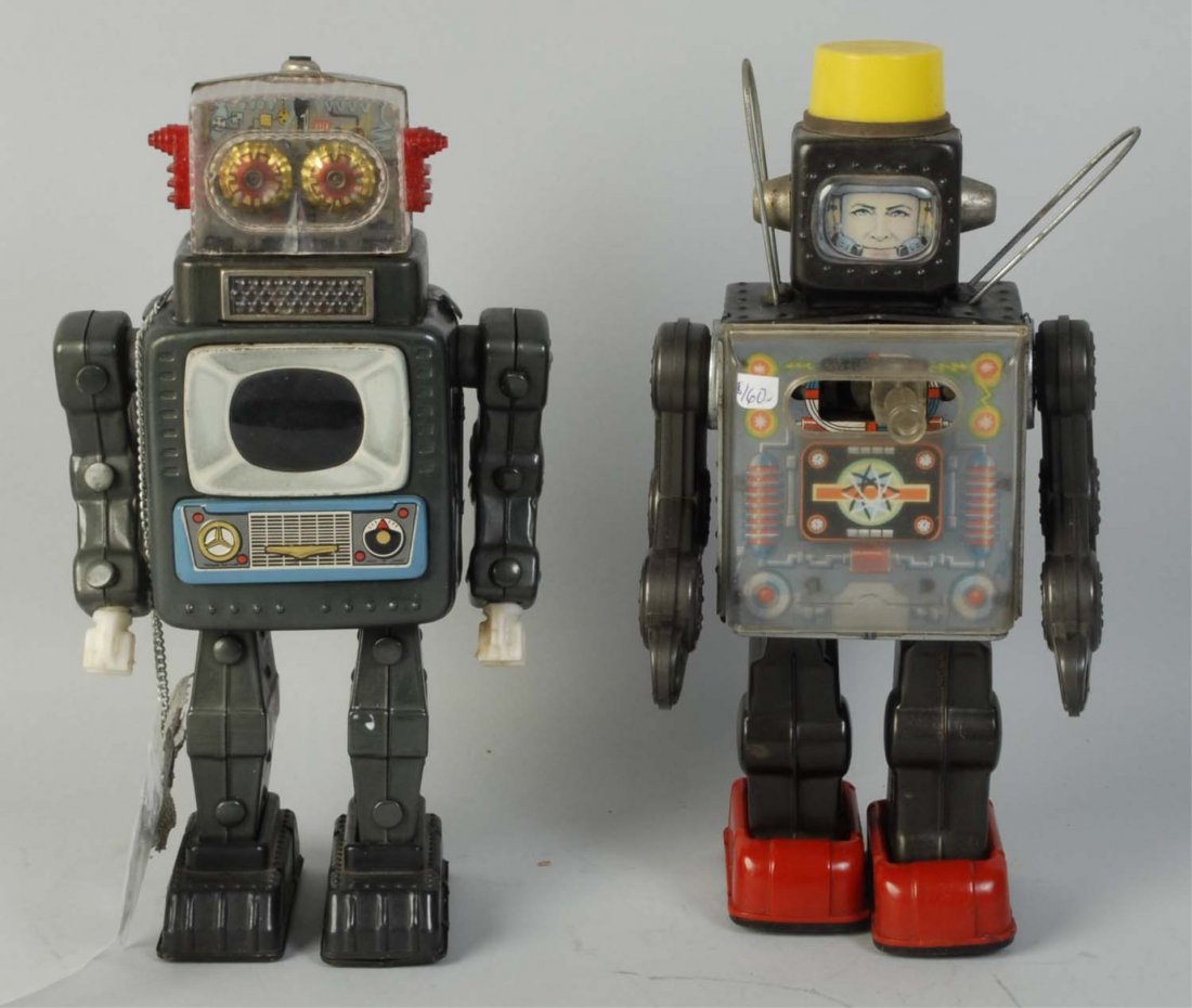 Lot of 2: Japanese Tin & Plastic Batt. Op. Robots: Includes a television space man with original antenna and a fighting space man. Plastic chest has some minor scratching but no cracking on the fighting space man. Battery boxes are fairly clean with s
