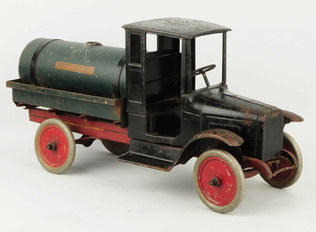 Pressed Steel Buddy L Tank Truck.: Circa 1920s. Missing top tank cap. Has original rear nozzle and original decals that are somewhat faded. Truck has scratching, some pitting to the metal, and some paint loss especially on fenders and 