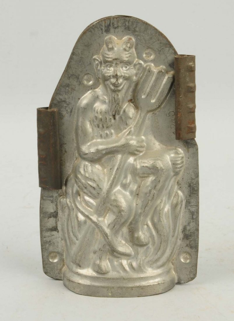 German Devil Chocolate Candy Mold.: This mold depicts the devil seated on a bed of flames holding a pitch fork. Condition (Very Good). Size 6 - 3/4" T.
