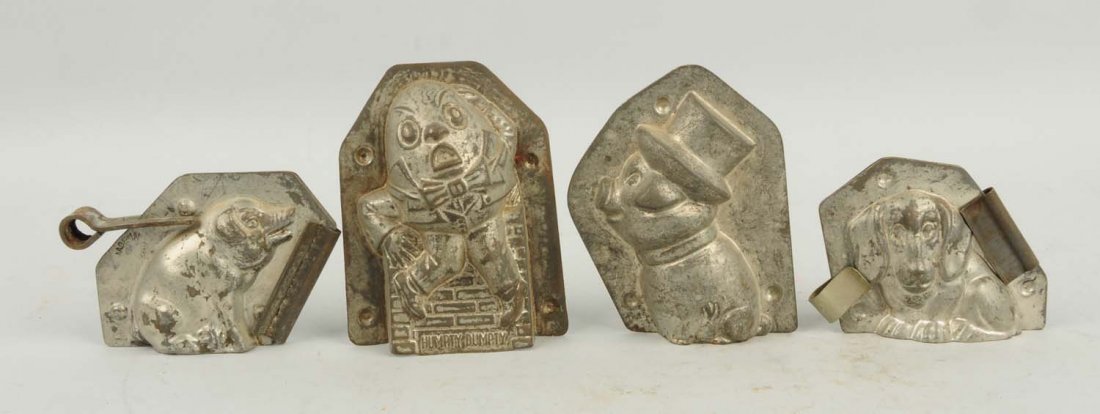 Lot of 4: Assorted Small Chocolate Molds.: This lot includes a Humpty Dumpty, two pigs and a dog. Condition (Very Good). Size Largest: 4 - 1/4" T.