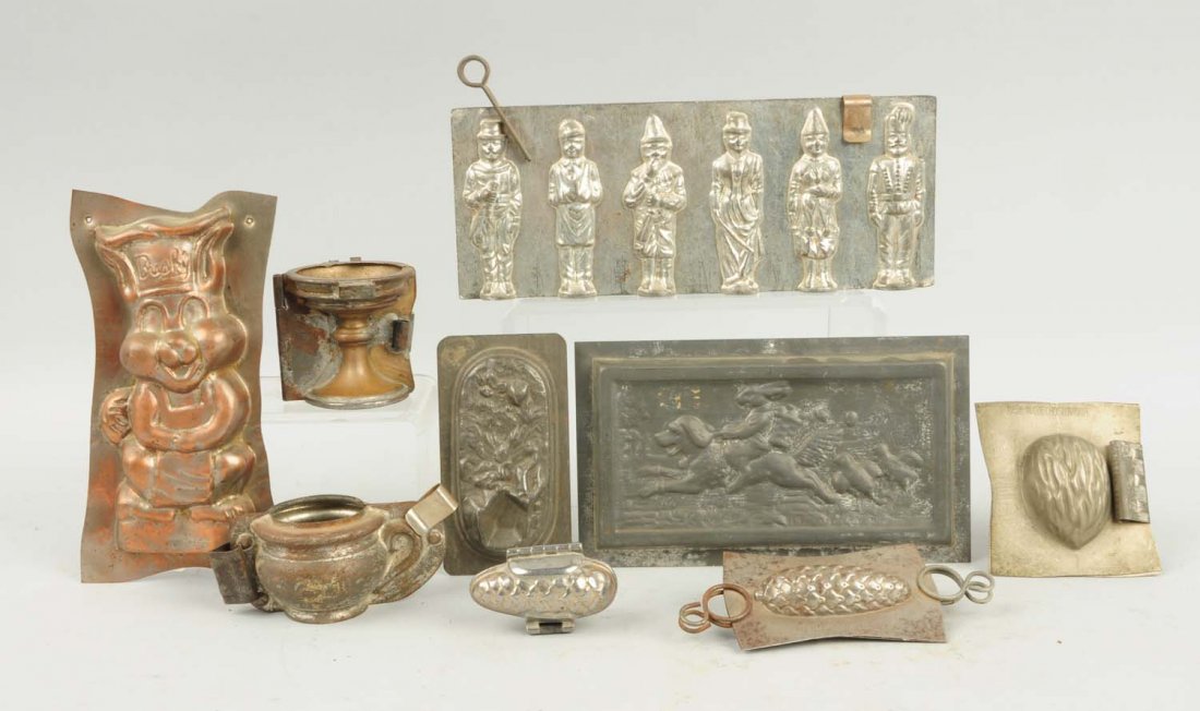 Lot of 9: Small Chocolate Molds.: This lot includes a Czech walnut mold, a small pinecone mold, a small chamber pot mold and others. Condition (Very Good). Size Largest: 7" T.