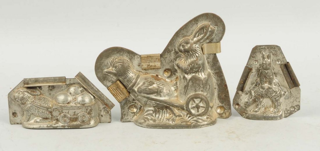 Lot of 3: Rabbit Chocolate Molds.: This lot includes one rabbit pulling a cart, one chicken pulling a cart and one other with two rabbits. Condition (Very Good). Size Largest: 6 - 1/4" L.