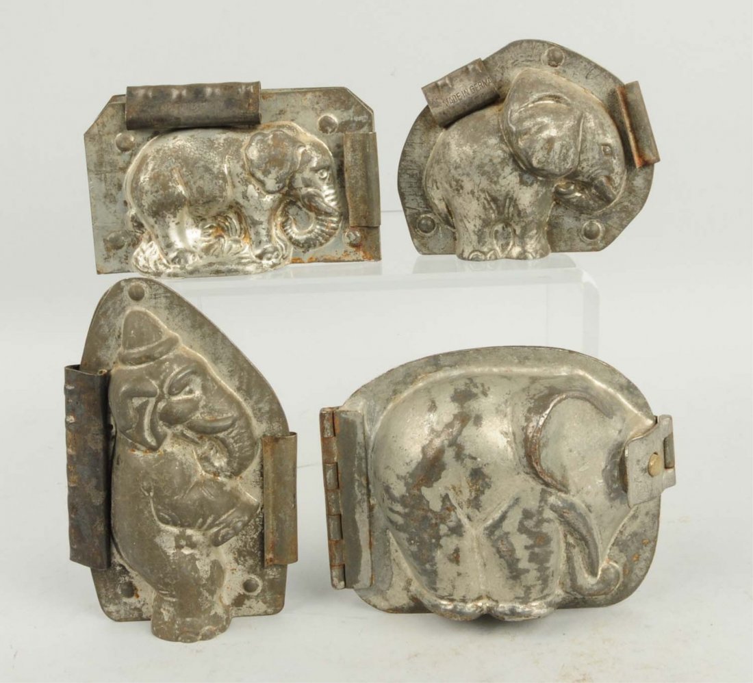 Lot of 4: Elephant Chocolate Molds.: This lot includes one elephant standing on hind legs, one stylized elephant and two others. Condition (Very Good). Size Largest: 5 - 1/4" T.