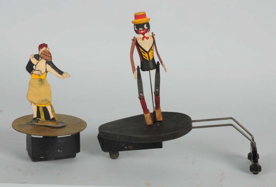 Lot of 2: Dancing Phonograph Toys.: One toy is a couple with the original jiro. The other is a minstrel figure. Condition (Good). Size Largest: 7 - 1/2" T.