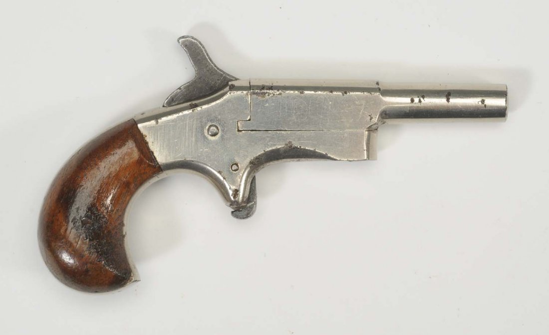 US .22 Cal. Pocket Pistol.: Serial No. 406 Unknown manufacturer single shot pocket or vest pistol in very good condition with nickel finish and walnut grips. Overall length 4 - 1/2” and barrel length 2 - 1/2”.