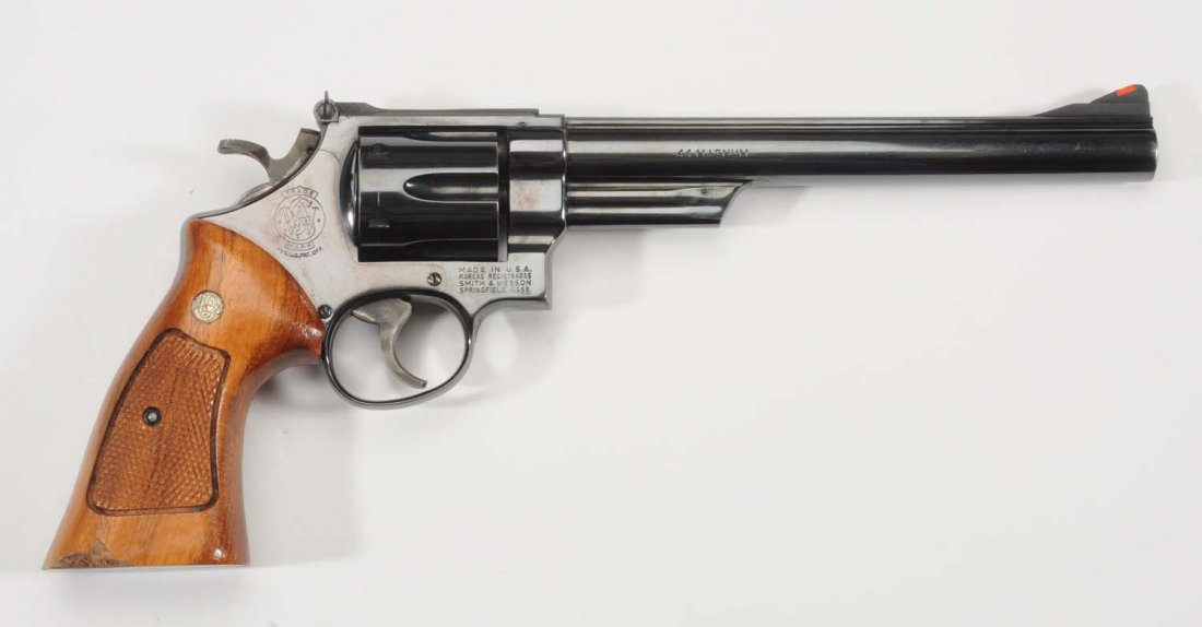 Smith & Wesson 29-4 .44 Cal. Revolver.**: Serial No. N800816. Barrel length 8 - 3/8". Adjustable rear sight. Bluing shows surface wear and rub marks. Left side grip in stained and right side has chipped wood at bottom. Light cylinder marks an