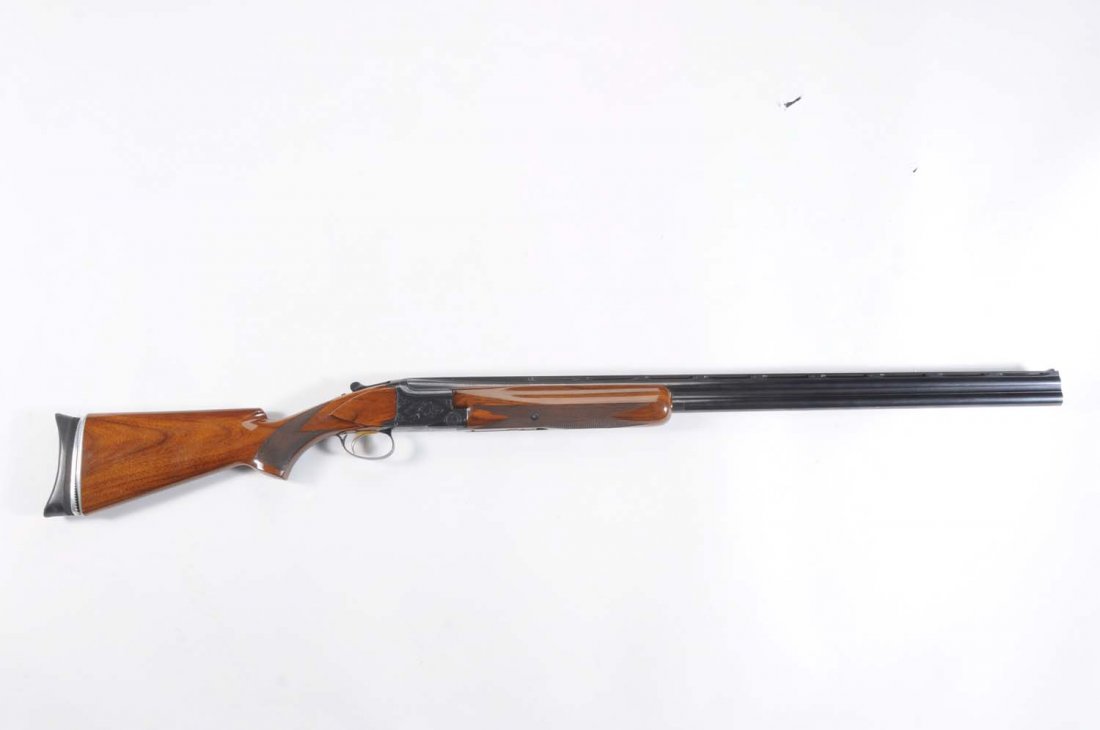 Browning Broadway Trap Belgium Shotgun.**: Serial No. 49623-S6. Barrel length 32" VR. Over/under. Chamber length 2 - 3/4". Choke dimension 1M and full. Length of pull 14 - 1/4". A bit of thinning blue at muzzle and high spots. Very light handl