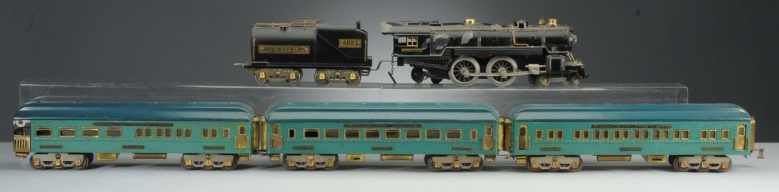 Standard Gauge Steam Locomotive & Passenger Cars.: The steam locomotive's rear truck has been replaced. The front truck wheels need to be replaced. The locomotive has been re-wheeled. There is significant paint loss on several spots along the boiler. 