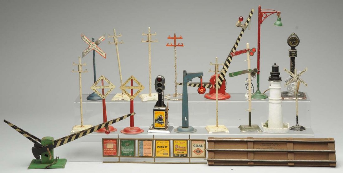 Assort. of Marx, American Flyer, European Signals: One Bing station clock scratched and worn paint. One brass set of signs for station platform. American Flyer manually operated banjo signal has some paint chips, missing parts. One modern China Keywes
