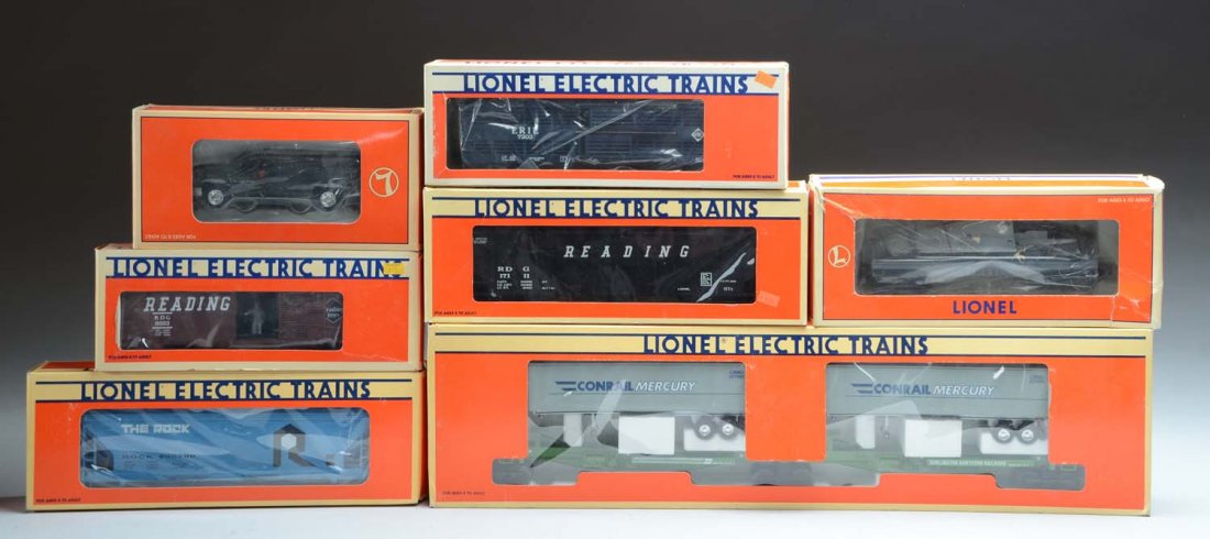 9Pc Lionel LTI Mostly Rolling Stock.: No.62041 1994 Lots Conventin car, No.17122 Rock Island hopper, No.9223 Reading operating box car, No.23011 O gauge right hand remote switch, No.18969 flat car with beach craft bonanza, No.18438 PRR do