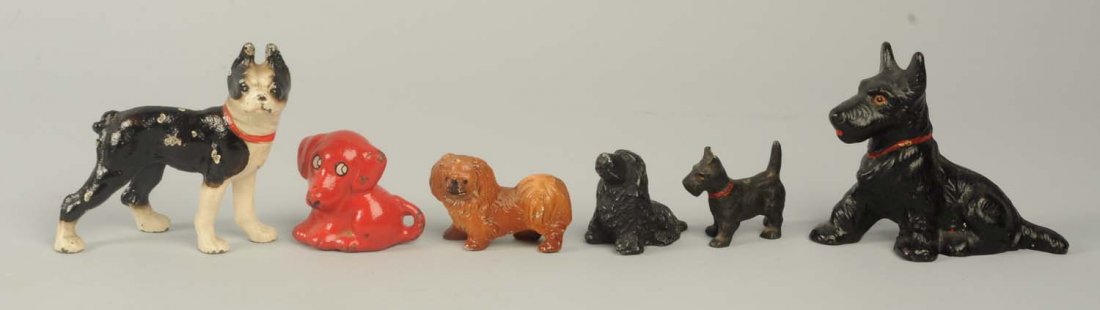 6 Cast Iron Dog Paperweights & Party Favors.: Includes a standing Boston Terrier and a Scottie paperweight. Hubley. Also includes a standing Scottie party favor; a Pekingese card holder; a Deco Dog pencil holder / paperweight, Spencer; Sitting Co