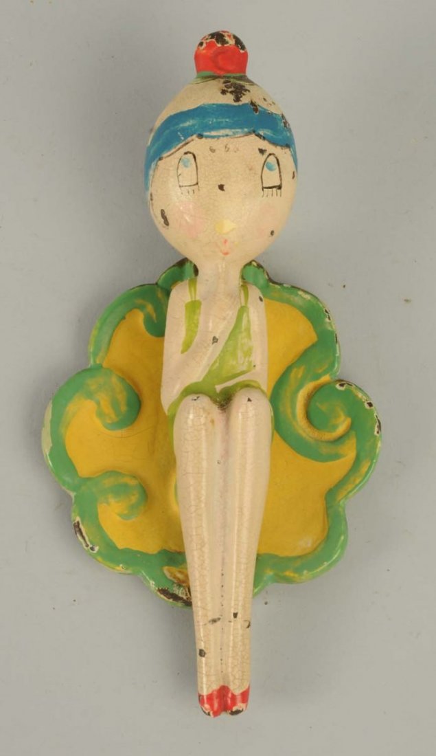 Cast Iron Bathing Beauties Doorknocker.: Depicts deco girl in 1920’s bathing suit. Made by Hubley, designer Anne Fish. Matches the series of doorstops. Condition (Excellent). Size 5 - 1/4" T .