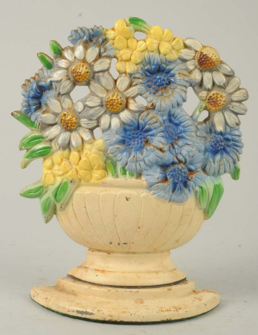 Cast Iron Daisy Bowl Flower Doorstop.: Assorted multi-colored daisies in bulbous bowl urn. Made by Hubley and numbered “452”. Condition (Excellent Plus). Size 7 - 1/2" T.