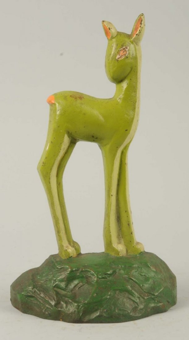 Cast Iron Fawn Doorstop.: Marked, “No. 6, © 1930, Taylor cook”. Depicts whimsical deer done in deco two tone green. Condition (Excellent Plus). Size 9 - 7/8" T.