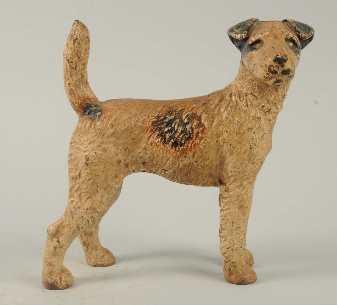 Cast Iron Wire Haired Fox Terrier Dog Doorstop.: Hubley, cat. #279. Full-figure, painted in natural colors. Condition (Very Good). Size 8" T.