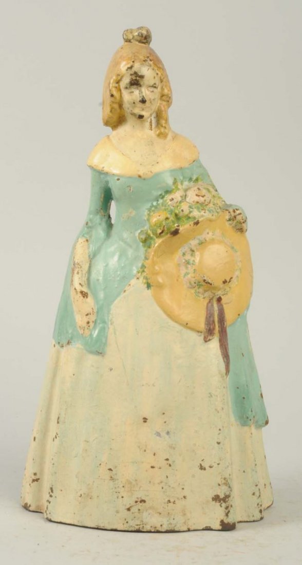 Cast Iron Southern Belle Doorstop.: National Foundry. Depicts lady holding bouquet of flowers and large hat. Condition (Very Good). Size 11 - 3/4" T.