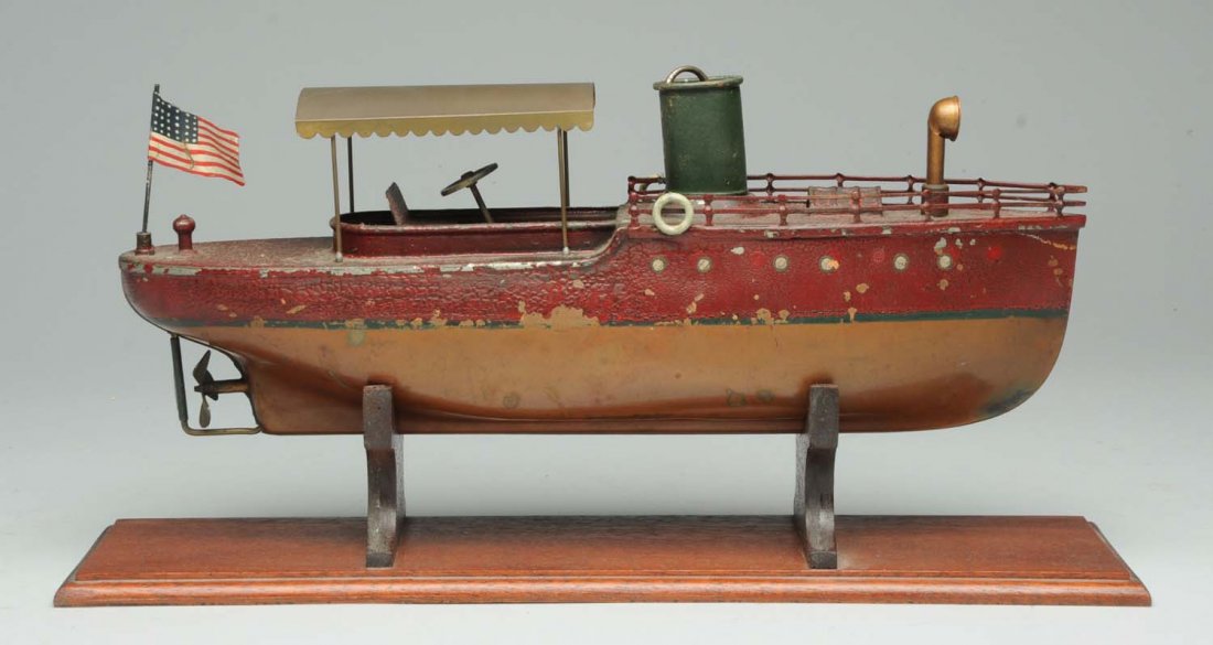 Tin Orkin Clockwork River Boat.: Circa 1920s. Working. Has replacement canopy, rear flag, and front funnel. Copper construction with brass trim. Includes wooden stand. Condition (Very Good). Size 14 - 1/2" L .